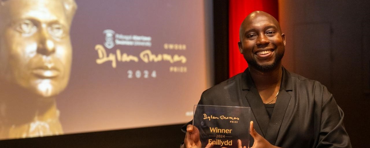 Caleb Azumah Nelson, Small Worlds (Viking, Penguin Random House), holding trophy 