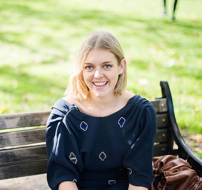 An image of Eccie Newton sitting on a bench outdoors