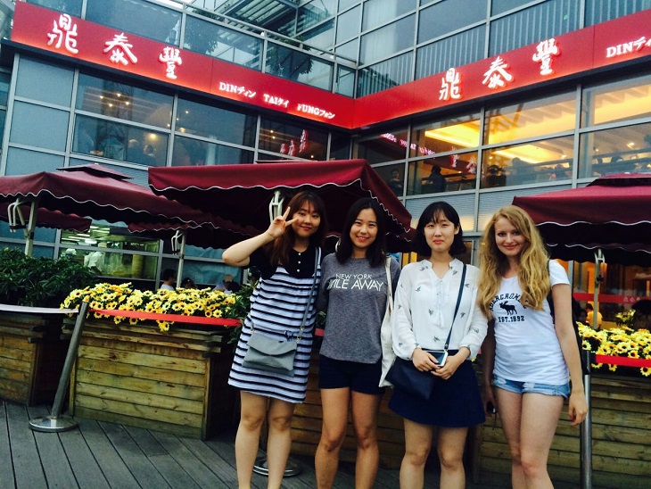 4 Students outside a market