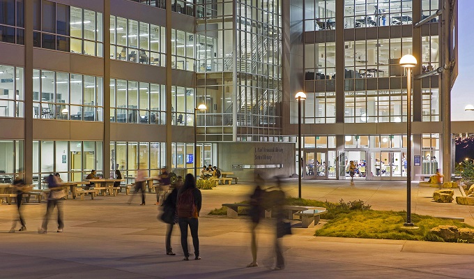 Students walking in and out of a university building