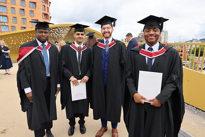 graduates on a bridge