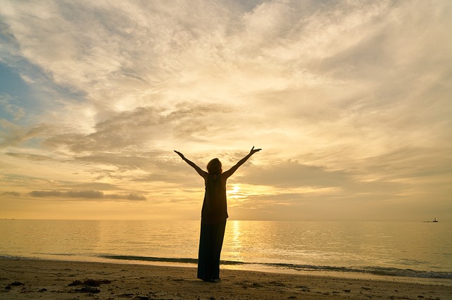 Lady holding hands up to sky