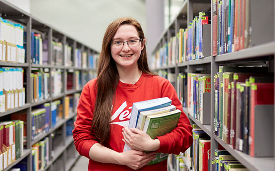 student holding books