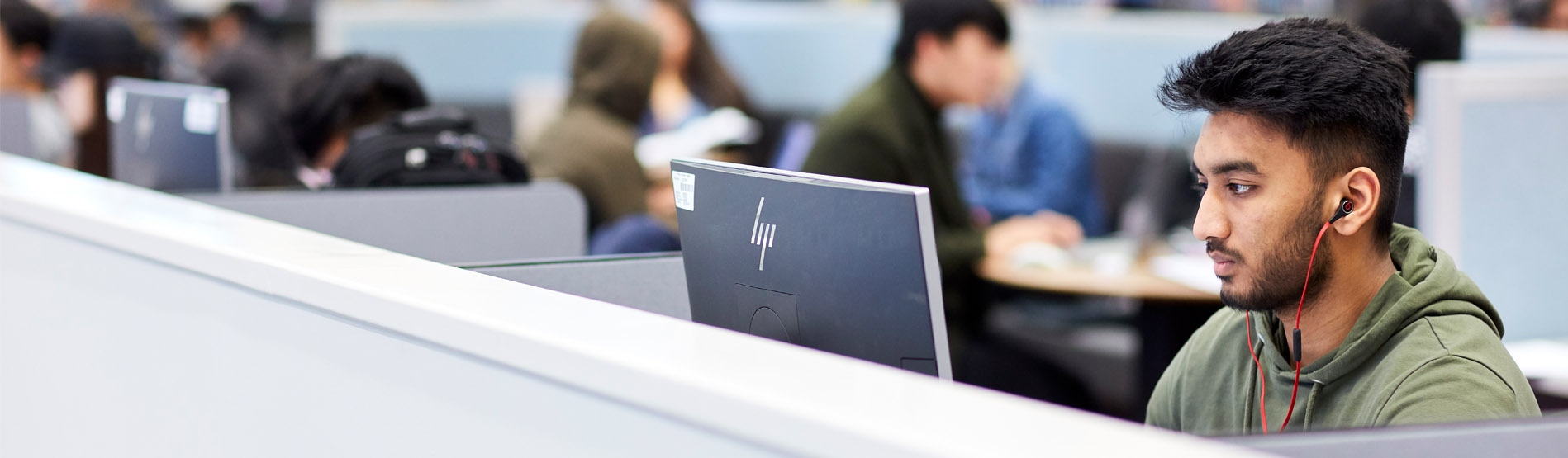 A student working at a computer in the library