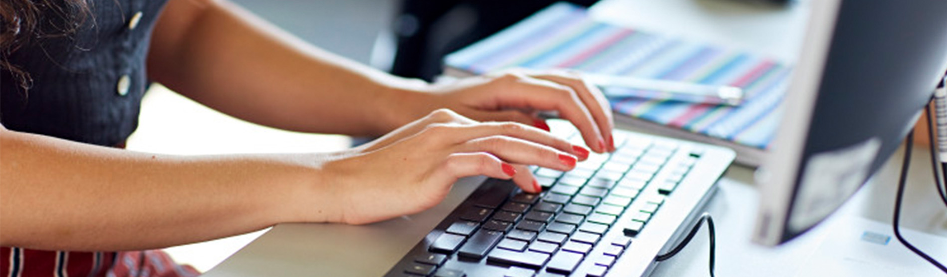 hands typing on keyboard