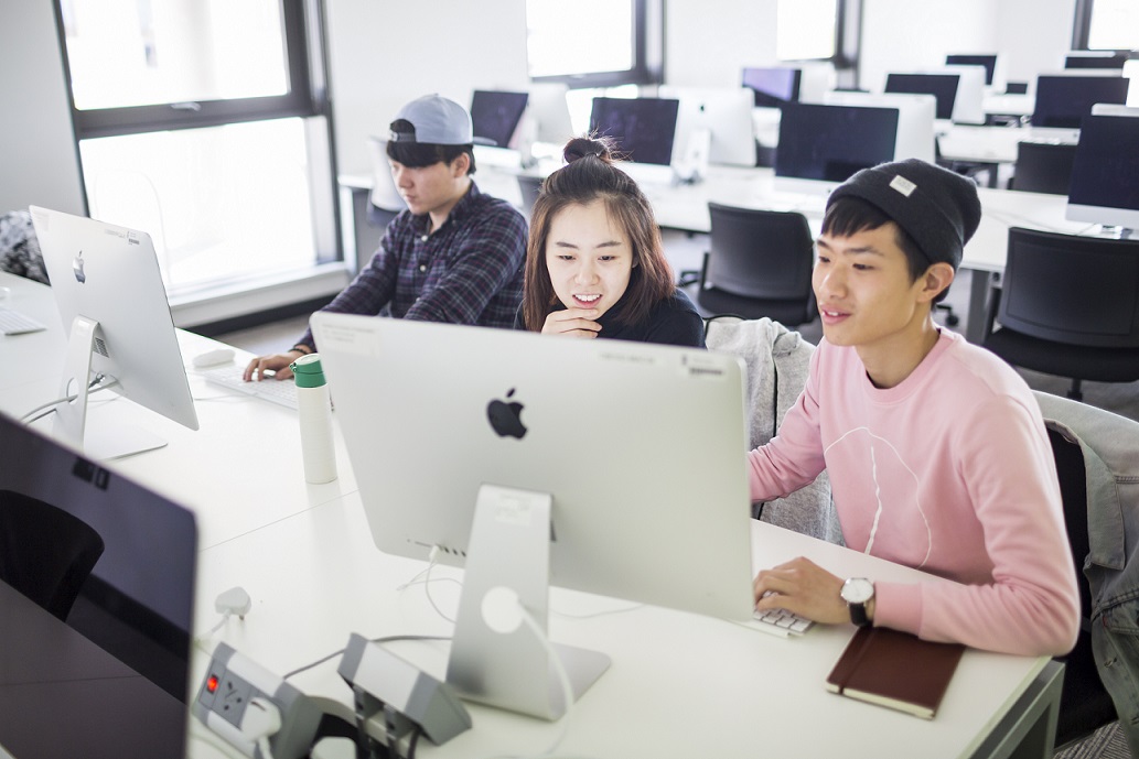 Students looking at a computer terminal