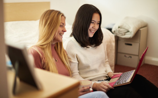 Two students using a laptop