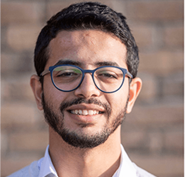 A portrait photo of Nabil smiling at the camera.