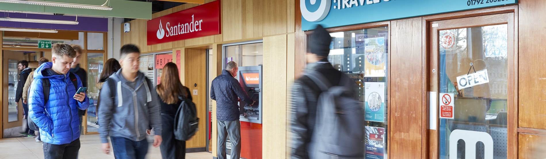 Students walking past Santander bank