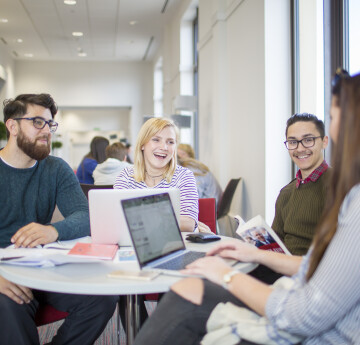 People discussing benefits and rewards around a table