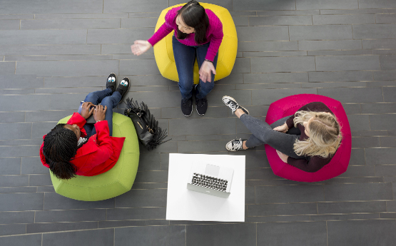 Image of three people chatting, casually