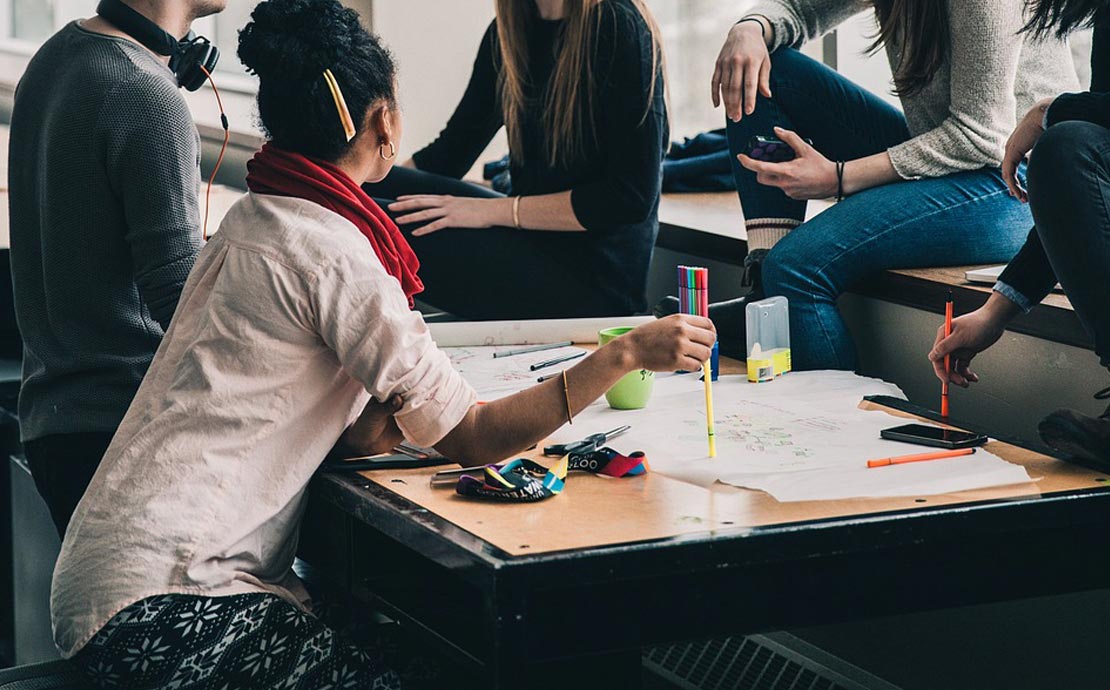 a group of people having a conversation in a business setting