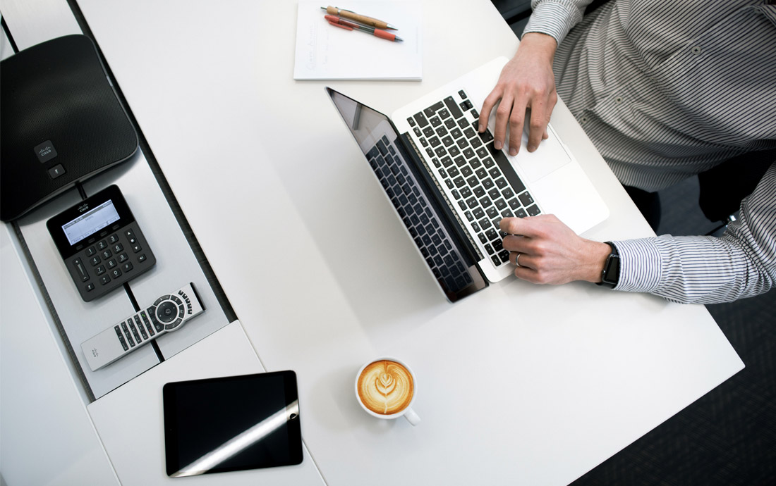 A man typing on a laptop