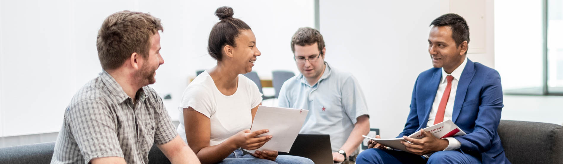 A group of students chatting and working