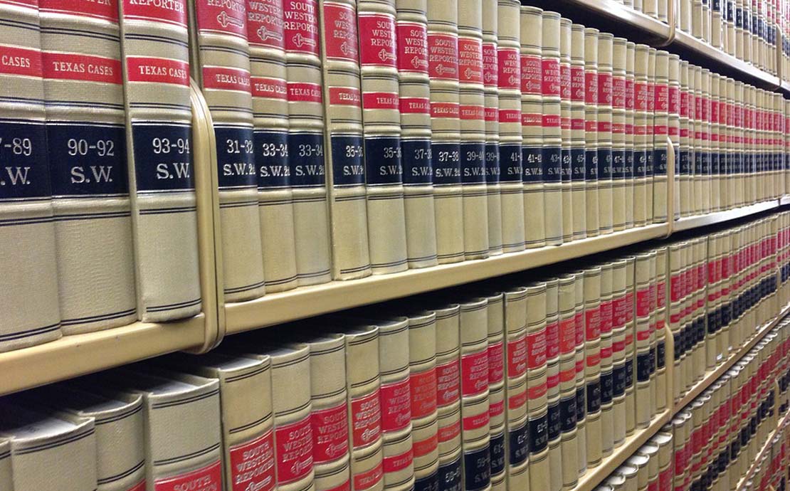 a row of antique books in a library