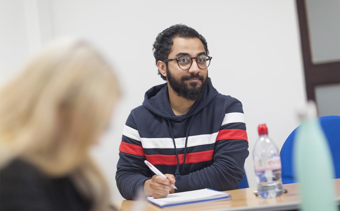 a student sitting in a lecture writing notes