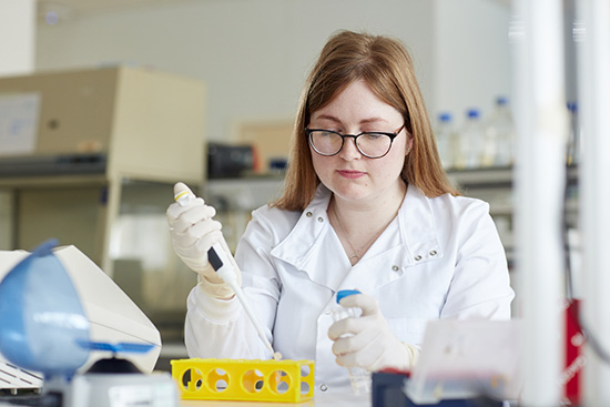 student with pippet in lab 