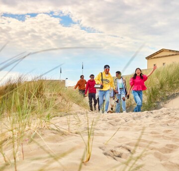 Students walking onto beach