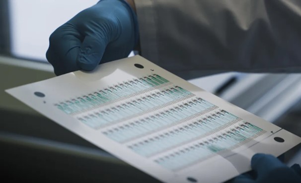 scientist holding research results on paper