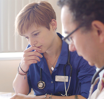 Medicine Student and Lecturer looking at patient records