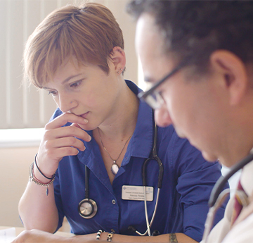 Two Doctors studying papers