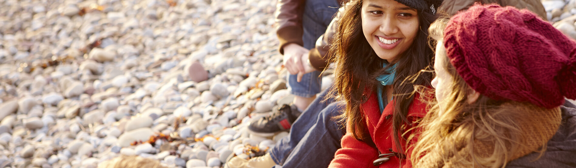 Students sitting on beach