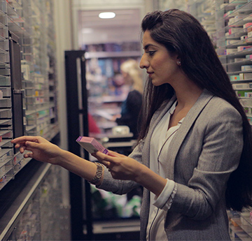 Student in a Pharmacy looking at drugs