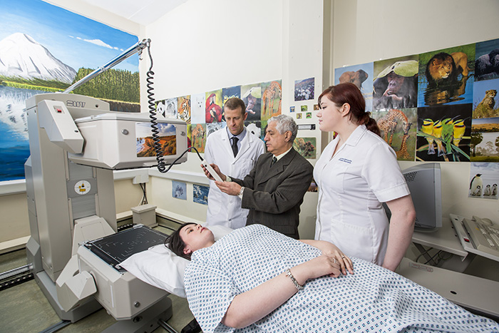 Academic and student assessing patient 