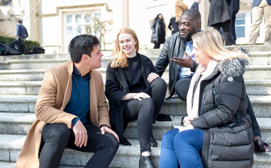 PG students sat on the steps outside Singleton Abbey chatting.