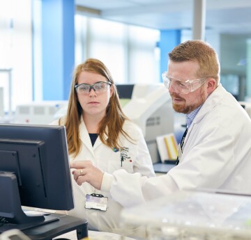 student and lecturer in a lab