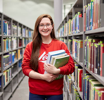 student holding books