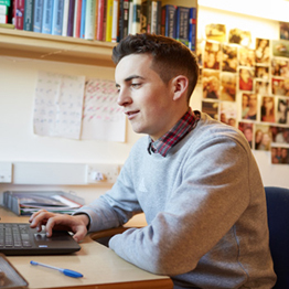 A student on his laptop in student halls