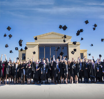 Students on graduation throwing their caps in the air