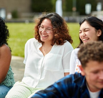 Two female students chatting and smiling