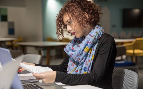 A female student sat at a computer.