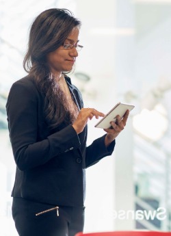 Woman in meeting room with an iPad