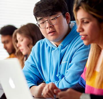 students working together on a laptop