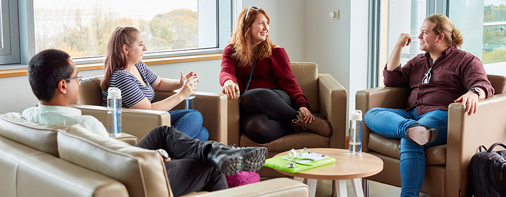 Students meeting in the hub in ILS2 with sea view in background