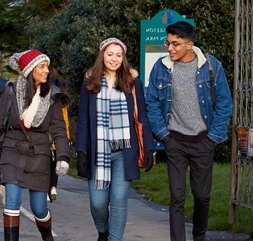 three students walking through the park