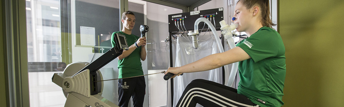 Students undergoing experiment on rowing machine