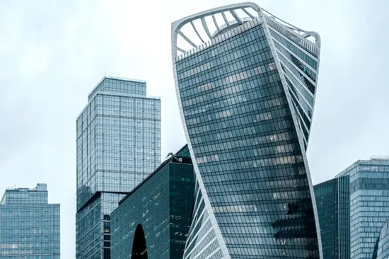 A complex of high-rise glass-fronted office buildings.