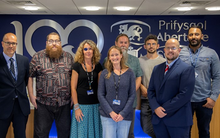 The image shows Swansea University staff with Gower College Swansea staff. 