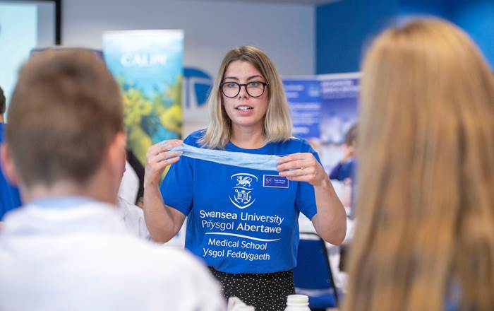 Swansea University Medical School student helping to explain nanotechnology to pupils from across Neath Port Talbot at the NanoBach event.