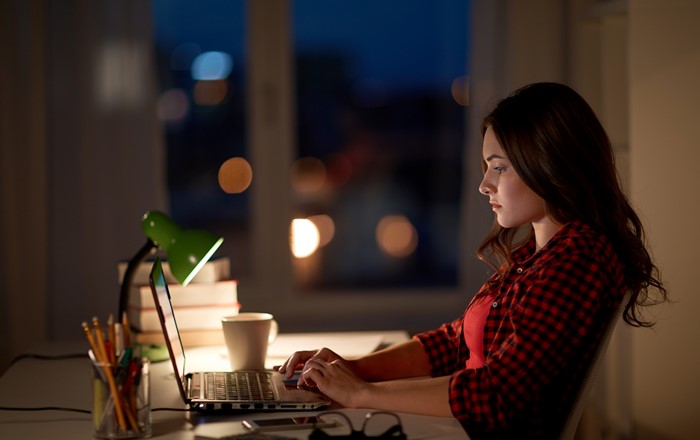 Female student sitting at laptop