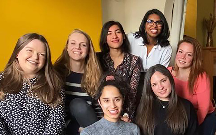 Group of medical students sitting together smiling. The Graduate Entry Medicine students from Swansea University who are offering to provide emergency relief childcare to Swansea health workers.