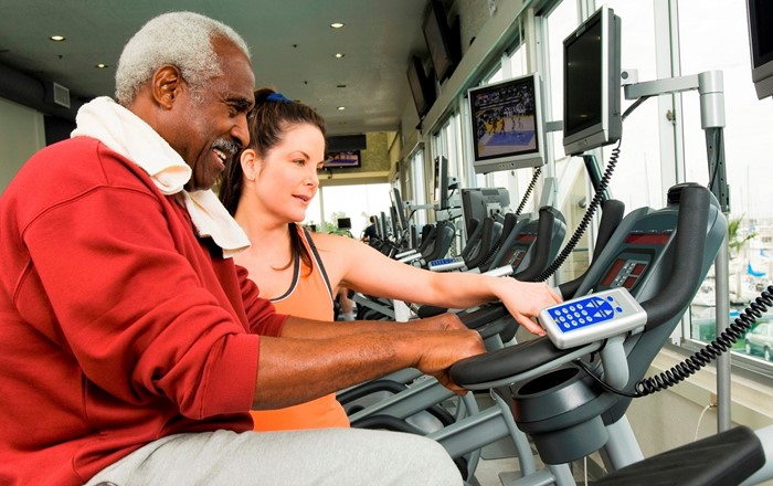 Man on exercise bike: physical exercise and improving activity levels are central parts of cardiac rehabilitation, which aims to boost the health and fitness of people with heart problems. 