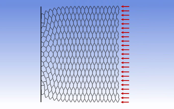 Hexagonal lattice material approaching buckling under compression © Micah Arago.