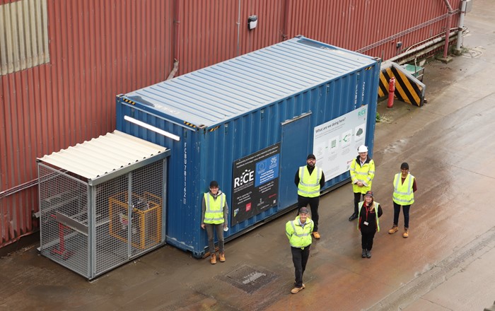 Aerial shot of six members of the RICE and ROCKWOOL team shown at the demonstration unit following its successful installation.