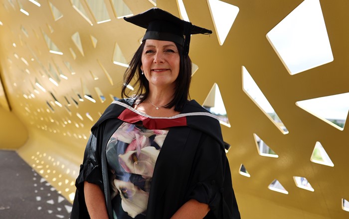 A photo of Michelle Morgan in her graduation cap and gown.