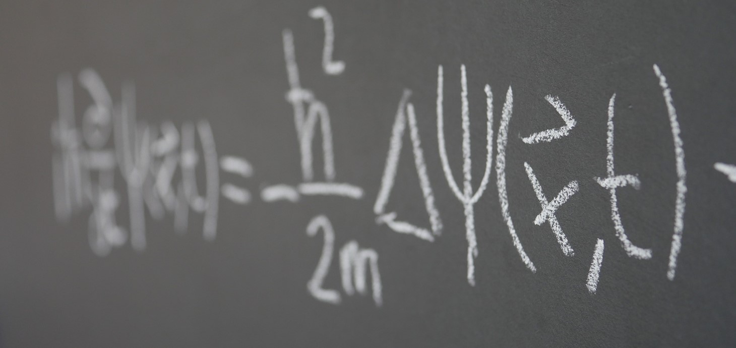 A mathematical equation written in chalk on a blackboard 